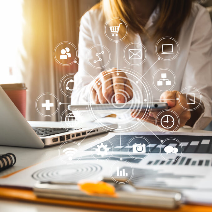 Digital marketing media in virtual screen.businesswoman hand working with mobile phone and modern compute with VR icon diagram at office in morning light